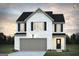 Charming two-story home with white brick, black shutters, and a two-car garage at 5389 Tolar Road # 36, South Fulton, GA 30213