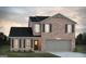 Charming two-story brick home featuring a two-car garage, black shutters, and a well-maintained lawn at 5360 Tolar Rd # 72, South Fulton, GA 30213