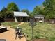 The backyard shows a storage shed with a swing and outdoor dining area with beautiful, landscaped lawn at 363 Palmetto Rd, Tyrone, GA 30290