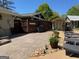 Backyard patio with outdoor grill, seating area, and storage shed with beautiful landscaping at 363 Palmetto Rd, Tyrone, GA 30290