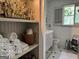 Bathroom with cabinet storage, patterned floors, and shelving at 363 Palmetto Rd, Tyrone, GA 30290