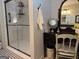 Bathroom featuring black and white tile floors, a glass shower, and a vanity with mirror at 363 Palmetto Rd, Tyrone, GA 30290