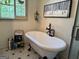Bathroom featuring soaking tub, patterned floor, and walk-in shower at 363 Palmetto Rd, Tyrone, GA 30290