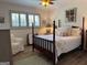 Bedroom featuring a four-poster bed, shutters, wood floors and chair at 363 Palmetto Rd, Tyrone, GA 30290