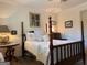 Bedroom with four-poster bed, bedside table, lamp and decorative accessories at 363 Palmetto Rd, Tyrone, GA 30290