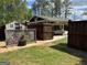 View of a carport area, with lattice and a parked car at 363 Palmetto Rd, Tyrone, GA 30290