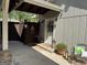 Cozy entryway with decorative lanterns, a comfortable bench and potted plants at 363 Palmetto Rd, Tyrone, GA 30290