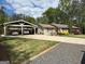 Beautiful house with a charming carport and a well-maintained lawn at 363 Palmetto Rd, Tyrone, GA 30290