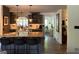 Modern kitchen with gray cabinets, granite countertops, an island with seating, and stainless steel appliances at 363 Palmetto Rd, Tyrone, GA 30290