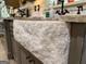 Detailed shot of a stone farmhouse sink and granite countertops in a kitchen with gray cabinets and hardware at 363 Palmetto Rd, Tyrone, GA 30290