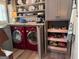 This laundry room features a washer and dryer, built-in shelving, and storage for household supplies at 363 Palmetto Rd, Tyrone, GA 30290