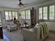 Bright living room with a window wall, ample seating and a ceiling fan at 363 Palmetto Rd, Tyrone, GA 30290