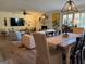 Open-concept living room with a dining area, fireplace, and lots of natural light from the large windows at 363 Palmetto Rd, Tyrone, GA 30290