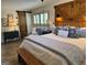Bright main bedroom boasts wood floors, a decorative barn door, and a custom wood headboard at 363 Palmetto Rd, Tyrone, GA 30290