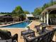 Beautifully landscaped backyard with an inground pool, lounge chairs, and outdoor seating area for entertaining at 363 Palmetto Rd, Tyrone, GA 30290