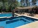 Backyard pool area with hot tub and outdoor furniture, ideal for relaxation and entertaining guests at 363 Palmetto Rd, Tyrone, GA 30290
