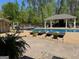 Relaxing backyard pool and deck area with covered gazebo, lounge chairs, and lush greenery at 363 Palmetto Rd, Tyrone, GA 30290