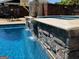 The pool's stone waterfall adds a touch of nature to the backyard oasis at 363 Palmetto Rd, Tyrone, GA 30290
