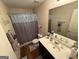 Bathroom with decorative shower curtain, spacious vanity, and well-lit mirror at 6539 Saint Mark Way, Fairburn, GA 30213