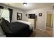 Bedroom with a black bed, dresser with TV, and a large window for natural light at 6539 Saint Mark Way, Fairburn, GA 30213