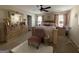 The main bedroom showcases a decorative bed, ceiling fan, white rug, and ample natural light from nearby windows at 6539 Saint Mark Way, Fairburn, GA 30213