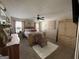 The main bedroom showcases a decorative bed, ceiling fan, white rug, and ample natural light from nearby windows at 6539 Saint Mark Way, Fairburn, GA 30213