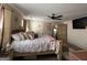 The main bedroom showcases a decorative bed, ceiling fan, white rug, and ample natural light from nearby windows at 6539 Saint Mark Way, Fairburn, GA 30213