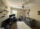 Bedroom featuring a couch, plush rug, wall art, and a computer station in a versatile and stylish atmosphere at 6539 Saint Mark Way, Fairburn, GA 30213