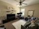 Bedroom space with a cozy couch, white rug, a TV, wall decor, and a corner computer space, creating a versatile and stylish atmosphere at 6539 Saint Mark Way, Fairburn, GA 30213