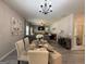 Elegant dining room with a modern table setting, chairs, and a chandelier at 6539 Saint Mark Way, Fairburn, GA 30213