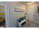 Inviting entryway with a stylish bench, modern art, and sleek, light-colored flooring at 6539 Saint Mark Way, Fairburn, GA 30213