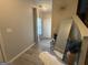 Hallway with a large mirror and decorative accents leading towards the staircase at 6539 Saint Mark Way, Fairburn, GA 30213