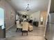 Open-concept living and dining area with elegant chandelier and abundant natural light at 6539 Saint Mark Way, Fairburn, GA 30213