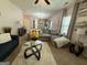 Spacious living room with comfortable seating, a large window, and modern decor at 6539 Saint Mark Way, Fairburn, GA 30213