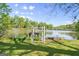 Scenic backyard featuring a lake view framed by a charming white gate and lush greenery at 30 Circle Dr, Hampton, GA 30228