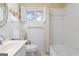 Bright white bathroom with tiled walls, classic fixtures, and natural light from the window at 30 Circle Dr, Hampton, GA 30228