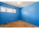 Simple bedroom featuring blue painted walls, carpet flooring, and a window offering natural light at 30 Circle Dr, Hampton, GA 30228