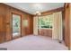 This dining room features classic wood paneling, neutral carpeting, and an elegant chandelier at 30 Circle Dr, Hampton, GA 30228