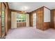 This dining room offers classic wood paneling, neutral carpeting, and views into the adjacent kitchen at 30 Circle Dr, Hampton, GA 30228