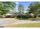 Traditional single story home featuring an attached carport and well maintained lawn and mature trees at 30 Circle Dr, Hampton, GA 30228