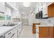 Bright kitchen featuring white cabinets, wood accents, and a stainless steel sink, with laminate flooring at 30 Circle Dr, Hampton, GA 30228