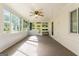 Spacious sunroom with abundant natural light, neutral carpet, and glass door for backyard access at 30 Circle Dr, Hampton, GA 30228
