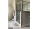 Bathroom with glass-enclosed shower with tile surround and neutral tile flooring at 160 Elysian Dr, Fayetteville, GA 30214