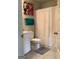 Charming bathroom with floral artwork, a white shower curtain, and convenient towel racks at 160 Elysian Dr, Fayetteville, GA 30214