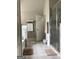 Bright bathroom with tiled flooring, a glass-enclosed shower, and a soaking tub at 160 Elysian Dr, Fayetteville, GA 30214