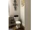 Cozy bathroom featuring a toilet, decorative wall art, and shelving unit for convenient storage at 160 Elysian Dr, Fayetteville, GA 30214