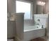 Bathroom featuring a built-in tub with tile surround, vanity, and updated fixtures at 160 Elysian Dr, Fayetteville, GA 30214