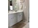 Bright bathroom features a double sink vanity with white cabinets, neutral walls, and framed mirrors at 160 Elysian Dr, Fayetteville, GA 30214