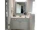 Bathroom vanity with a white cabinet, silver hardware, and a framed mirror at 160 Elysian Dr, Fayetteville, GA 30214