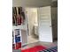 Bedroom with view to an ensuite bathroom, featuring shelving and organized decor at 160 Elysian Dr, Fayetteville, GA 30214